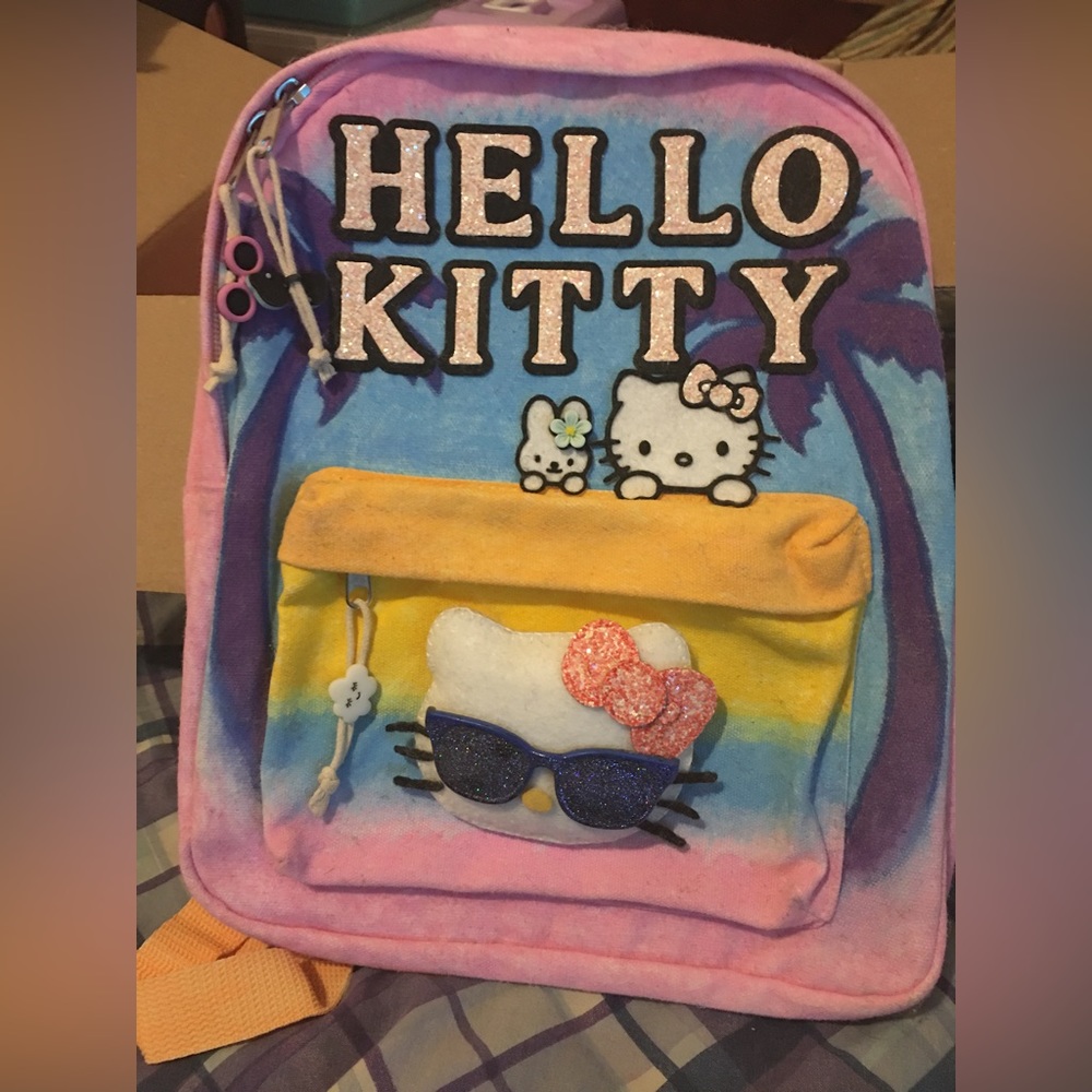Hello Kitty backpack, stuffed toy, notebook and five below collectible figures